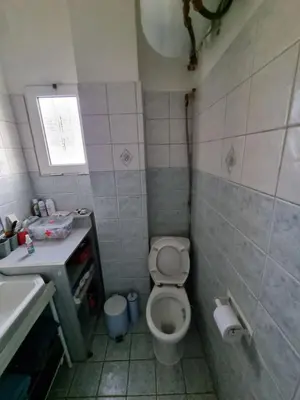 a small bathroom with a toilet and a sink at DianaHub in Artemida