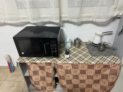 a microwave sitting on top of a table at DianaHub in Artemida