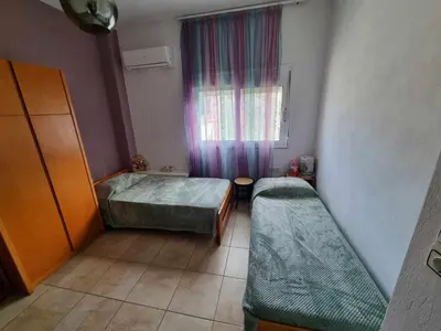 a small room with two beds and a window at DianaHub in Artemida