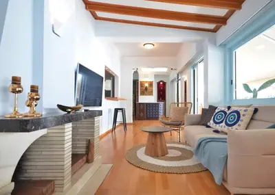 a living room with a couch and a fireplace at Piraeus Pasalimani LargeTerrace Seaview Apartment in Piraeus