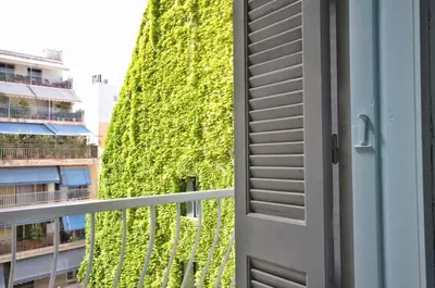 an open door to a building with a green wall at Piraeus Pasalimani LargeTerrace Seaview Apartment in Piraeus
