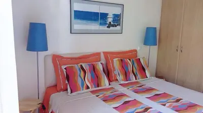 a bedroom with a bed with two blue lamps at Scenic View Apartment by Saronida Beach in Saronida
