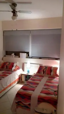 a bedroom with two beds and a large bed sidx sidx sidx at Scenic View Apartment by Saronida Beach in Saronida