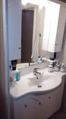 a bathroom with a sink and a mirror at Scenic View Apartment by Saronida Beach in Saronida