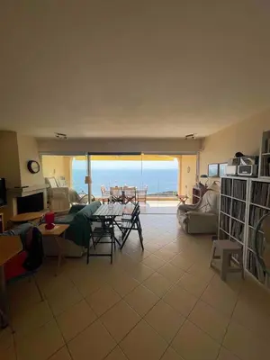 a living room with a view of the ocean at Scenic View Apartment by Saronida Beach in Saronida