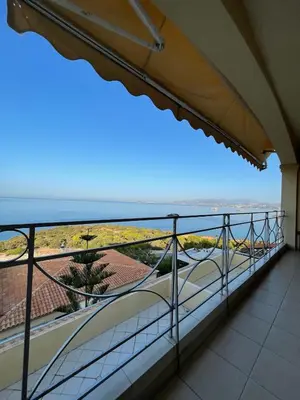 a balcony with a view of the ocean at Scenic View Apartment by Saronida Beach in Saronida