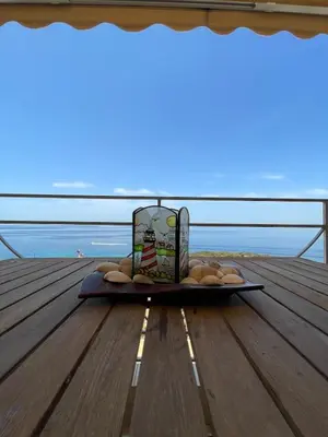 a tray of food sitting on a table on a deck at Scenic View Apartment by Saronida Beach in Saronida