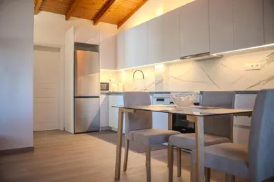 a kitchen with a table and chairs in a room at Combination of the sea and the countryside in Vari