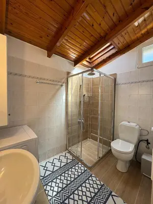 a bathroom with a shower and a toilet and a sink at Combination of the sea and the countryside in Vari