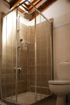 a shower stall in a bathroom with a toilet at Combination of the sea and the countryside in Vari