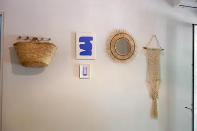 a wall with a mirror and a basket on a wall at New Spacious 3BR Apt Near Kypseli 8 min to Metro in Athens