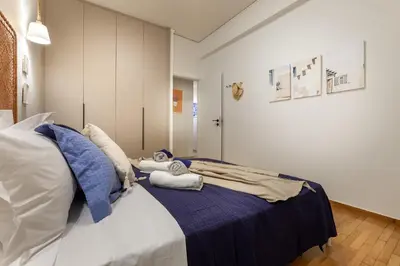 a bedroom with a bed with towels on it at New Spacious 3BR Apt Near Kypseli 8 min to Metro in Athens
