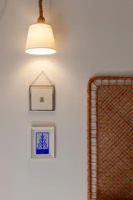 a room with two pictures on the wall and a light fixture at New Spacious 3BR Apt Near Kypseli 8 min to Metro in Athens
