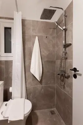 a bathroom with a shower with a toilet and a sink at New Spacious 3BR Apt Near Kypseli 8 min to Metro in Athens