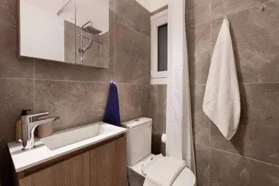 a small bathroom with a sink and a toilet at New Spacious 3BR Apt Near Kypseli 8 min to Metro in Athens