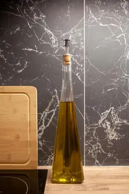 a bottle of oil sitting on top of a counter at New Spacious 3BR Apt Near Kypseli 8 min to Metro in Athens