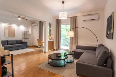 a living room with a couch and a table at Athena's Escape-Your Greek base! in Athens