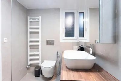 a bathroom with a white sink and a toilet at Athena's Escape-Your Greek base! in Athens