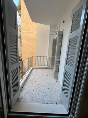 an open door of a room with a balcony at Athena's Escape-Your Greek base! in Athens