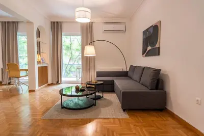 a living room with a couch and a table at Athena's Escape-Your Greek base! in Athens