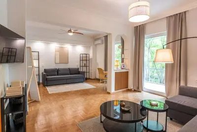 a living room with a couch and a table at Athena's Escape-Your Greek base! in Athens