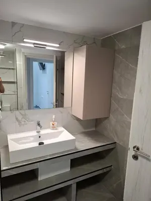 a bathroom with a white sink and a mirror at Nikaia Luxury Dream in Piraeus