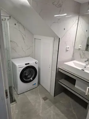 a bathroom with a washing machine and a sink at Nikaia Luxury Dream in Piraeus