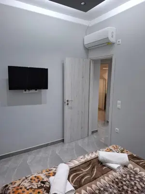 a living room with a bed and a flat screen tv at Nikaia Luxury Dream in Piraeus