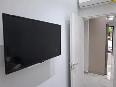 a flat screen tv hanging on a wall at Nikaia Luxury Dream in Piraeus
