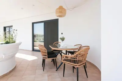 a dining room with a table and chairs at Luxury 3-BD condo with 80sqm balcony in Glifada in Athens
