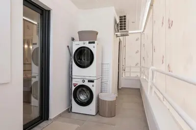 a laundry room with a washer and dryer at Luxury 3-BD condo with 80sqm balcony in Glifada in Athens