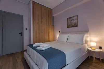 a bedroom with a bed with towels on it at Kallithea fresh in Athens