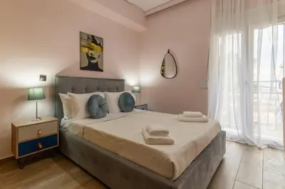 a bedroom with a large bed with towels on it at Kallithea fresh in Athens