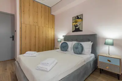 a bedroom with a large bed with towels on it at Kallithea fresh in Athens