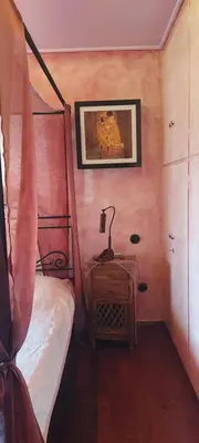 a bedroom with a bed and a lamp on a night stand at Beautiful apartment in the center of Glyfada in Athens
