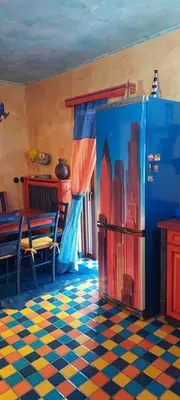 a dining room with a painting on the wall at Beautiful apartment in the center of Glyfada in Athens