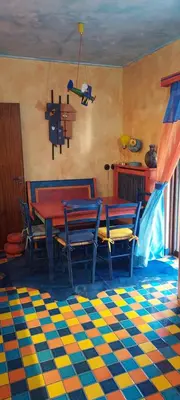 a dining room with a red table and chairs at Beautiful apartment in the center of Glyfada in Athens