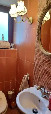 a bathroom with a sink and a mirror and a toilet at Beautiful apartment in the center of Glyfada in Athens