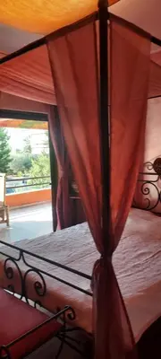 a bedroom with a bed with a canopy and a window at Beautiful apartment in the center of Glyfada in Athens