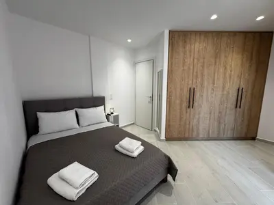 a bedroom with a bed with two towels on it at Calma Athens in Athens