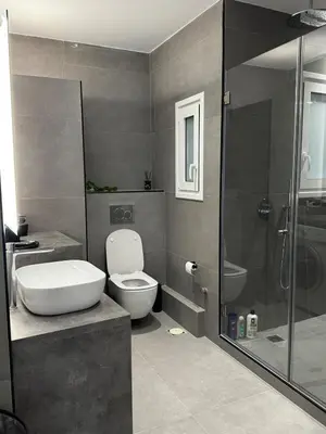 a bathroom with a toilet sink and a shower at Calma Athens in Athens