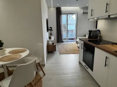 a kitchen and dining room with a table and chairs at Calma Athens in Athens