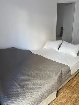 a large bed with white sheets and white pillows at Calma Athens in Athens