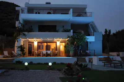 a view of a house at night at Aegean Pearl in Áyios Dhimítrios