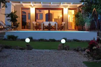 a house with two lights on the lawn at Aegean Pearl in Áyios Dhimítrios