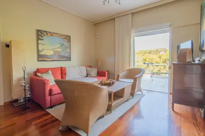 a living room with a couch and a table at Dream-Stay apartment with a spacious balcony in Athens