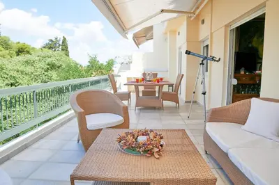 a balcony with a table and chairs and a camera at Dream-Stay apartment with a spacious balcony in Athens