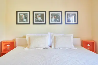 a bedroom with a bed with four pictures on the wall at Dream-Stay apartment with a spacious balcony in Athens