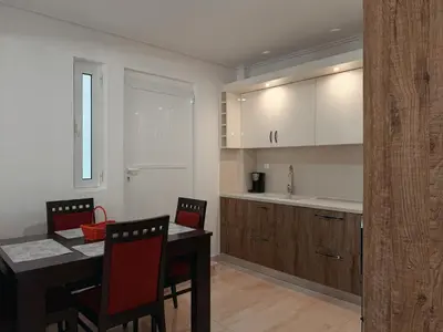 a kitchen with a table and chairs and a dining room at Seaview Complex with Pool in Porto Rafti