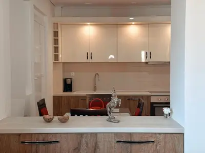 a kitchen with white cabinets and a counter top at Seaview Complex with Pool in Porto Rafti